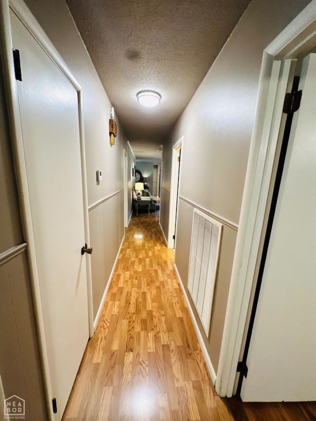 2804 Ivy Dr, Newport, AR 72112 - hall with light wood-style floors and a textured ceiling