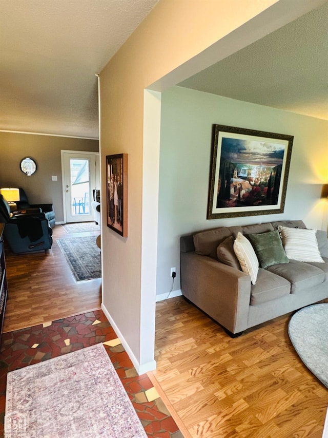 2804 Ivy Dr, Newport, AR 72112 - living area featuring wood finished floors, a textured ceiling, and baseboards