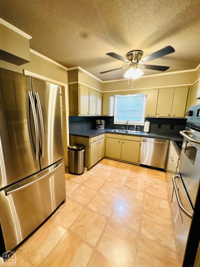 2804 Ivy Dr, Newport, AR 72112 - kitchen with appliances with stainless steel finishes, ceiling fan, dark countertops, crown molding, and a sink