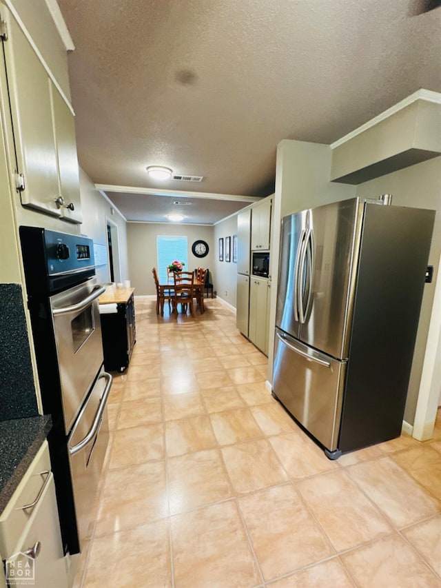 2804 Ivy Dr, Newport, AR 72112 - kitchen with appliances with stainless steel finishes, a textured ceiling, baseboards, and dark countertops