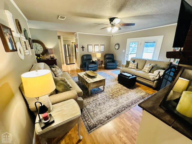 2804 Ivy Dr, Newport, AR 72112 - living area featuring a ceiling fan, wood finished floors, crown molding, and a textured ceiling