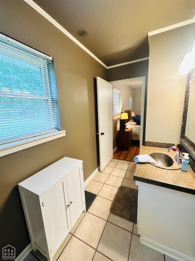 2804 Ivy Dr, Newport, AR 72112 - bathroom featuring vanity, ornamental molding, a textured ceiling, tile patterned flooring, and baseboards