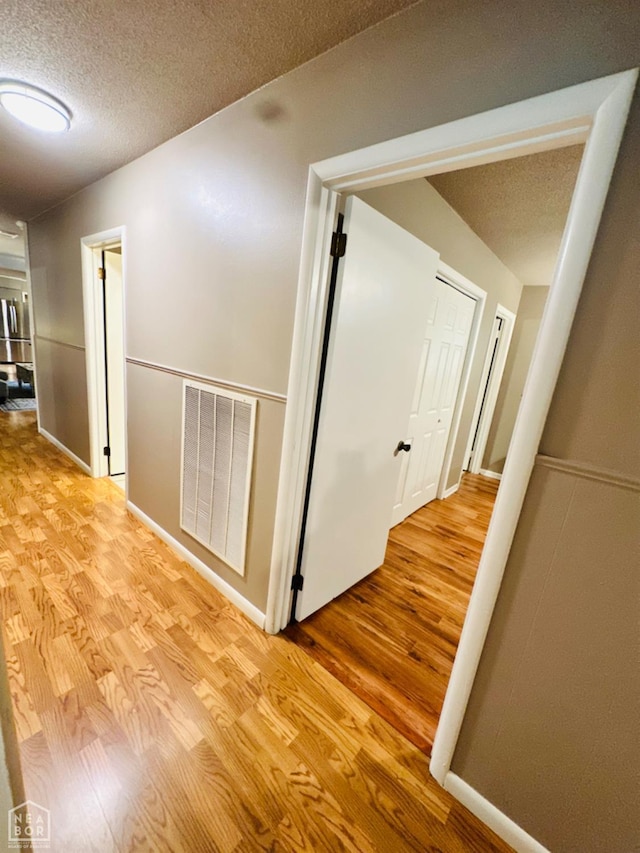 2804 Ivy Dr, Newport, AR 72112 - corridor with light wood-type flooring and a textured ceiling