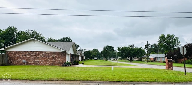 2804 Ivy Dr, Newport, AR 72112 - view of side of home featuring brick siding, concrete driveway, and a lawn