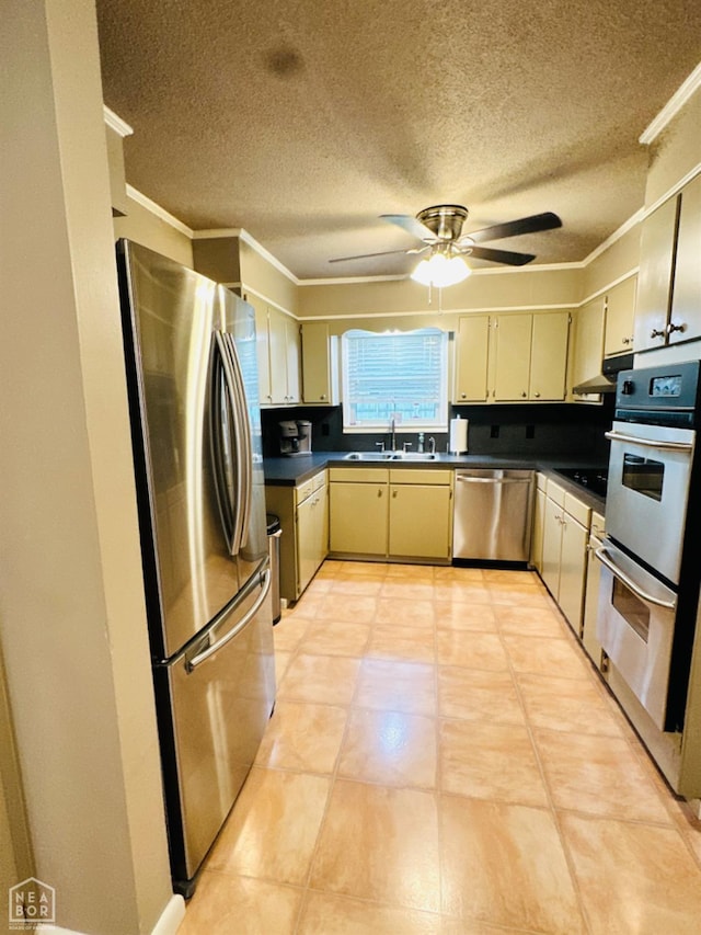 2804 Ivy Dr, Newport, AR 72112 - kitchen with stainless steel appliances, a sink, crown molding, dark countertops, and a textured ceiling