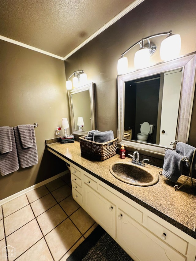 2804 Ivy Dr, Newport, AR 72112 - bathroom featuring a textured ceiling, tile patterned floors, ornamental molding, vanity, and baseboards
