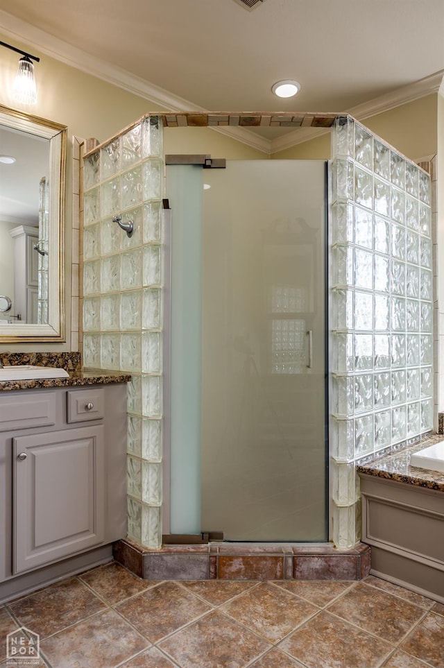 full bathroom featuring vanity, ornamental molding, and a stall shower