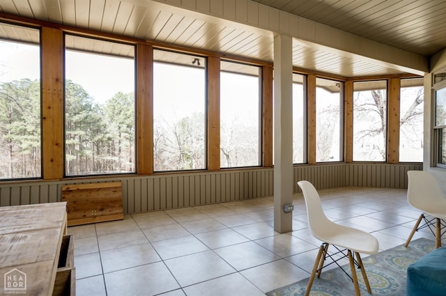 unfurnished sunroom with tile patterned flooring and wooden ceiling