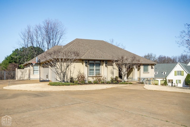 view of front of home featuring an attached garage, stucco siding, and concrete driveway