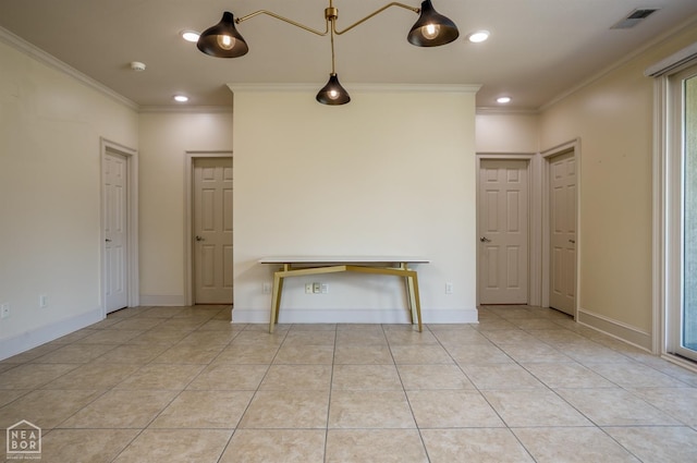 unfurnished living room with visible vents, baseboards, and crown molding