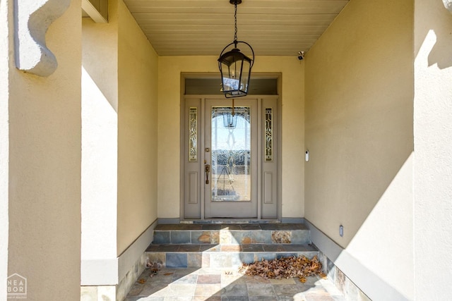 entrance to property featuring stucco siding