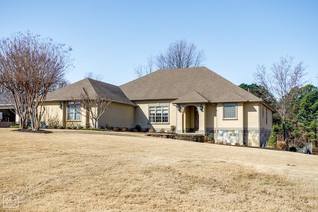 view of front of property with a front yard and stucco siding
