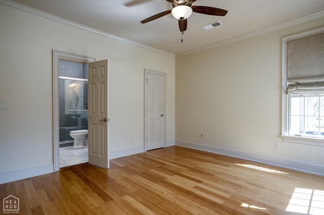 unfurnished bedroom featuring visible vents, baseboards, ensuite bathroom, ornamental molding, and light wood-style floors