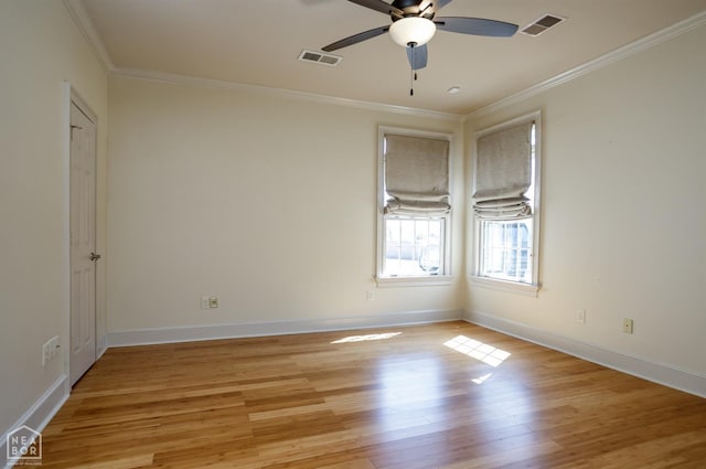 spare room with crown molding, visible vents, a ceiling fan, and light wood-style floors