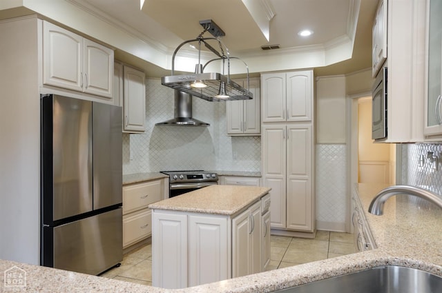 kitchen featuring light stone counters, ornamental molding, visible vents, and stainless steel appliances