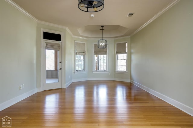 interior space featuring a wealth of natural light, light wood finished floors, visible vents, and an inviting chandelier