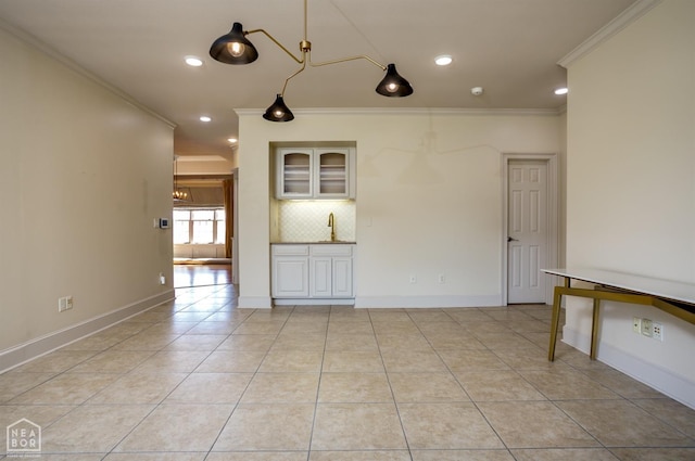 interior space with crown molding, light tile patterned floors, baseboards, and recessed lighting