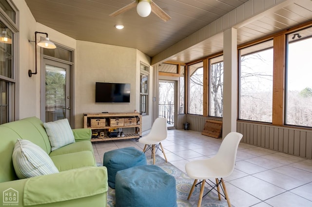 sunroom with wooden ceiling, an outdoor hangout area, a ceiling fan, and tile patterned flooring