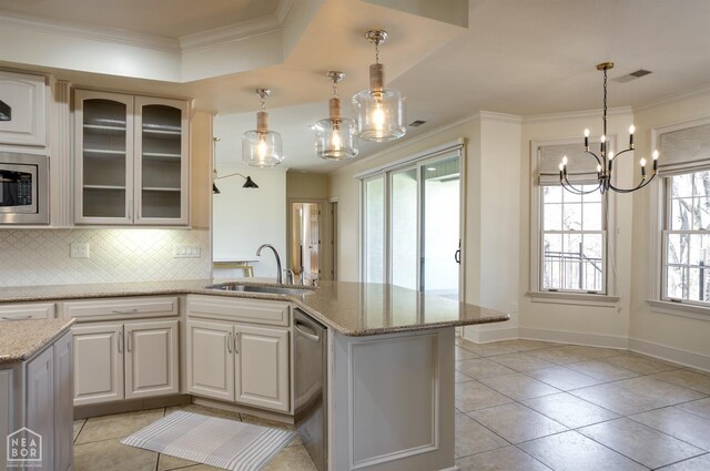 kitchen featuring backsplash, appliances with stainless steel finishes, a sink, and ornamental molding