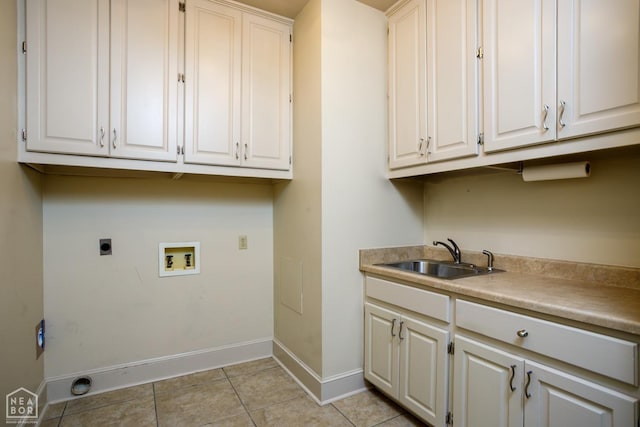 laundry area with electric dryer hookup, washer hookup, light tile patterned flooring, cabinet space, and a sink
