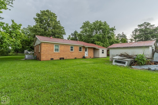 18020 Butterfly Rd, Harrisburg, AR 72432 - back of property with crawl space, a lawn, brick siding, and a metal roof