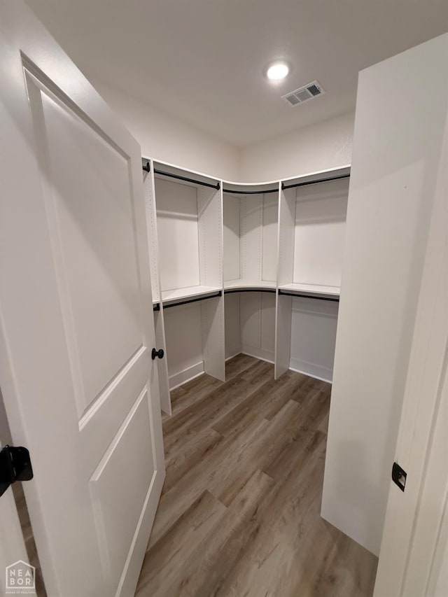 walk in closet featuring light wood-type flooring and visible vents