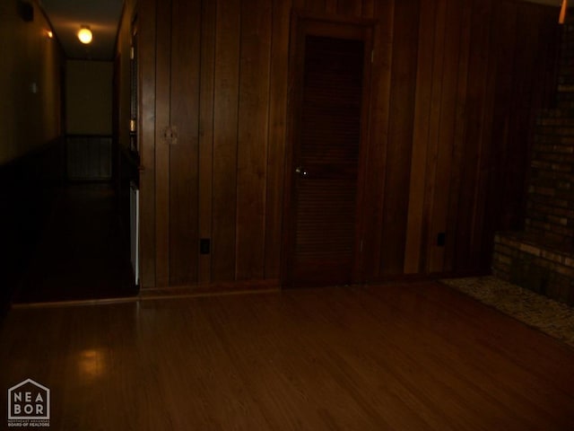 interior space featuring wooden walls and wood finished floors