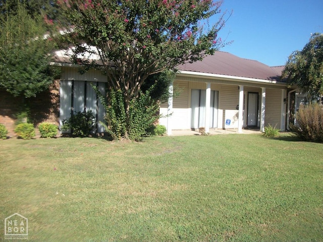 view of front of house featuring a front yard and metal roof