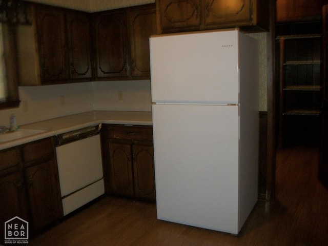 kitchen with white appliances, light wood-style floors, and light countertops