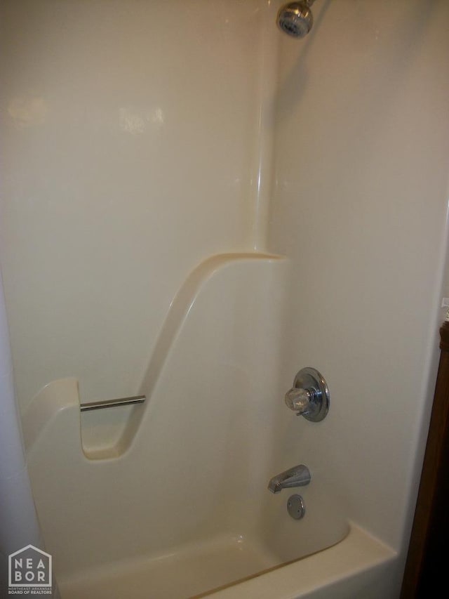 room details featuring shower / tub combination
