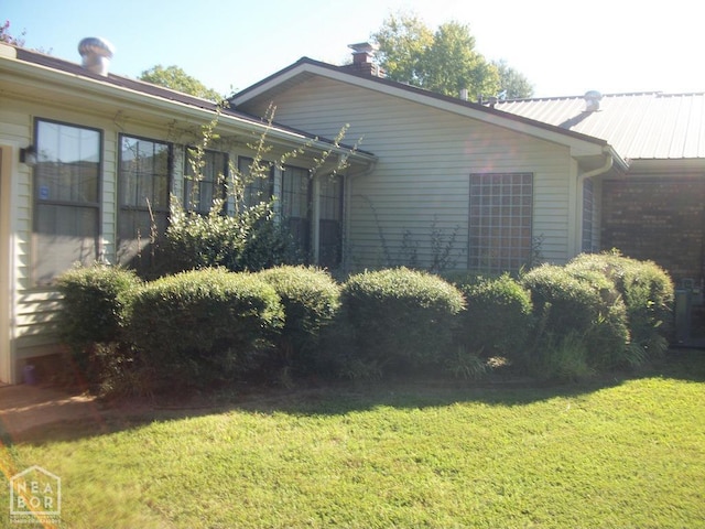 view of side of home featuring a yard