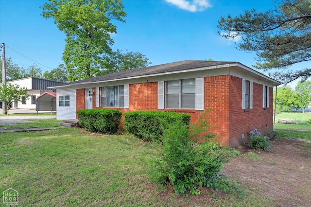208 S Rockingchair Rd, Paragould, AR 72450 - view of front of home with crawl space, brick siding, a front lawn, and a detached carport