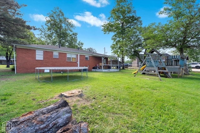 208 S Rockingchair Rd, Paragould, AR 72450 - view of green lawn featuring a trampoline, a playground, and a sunroom