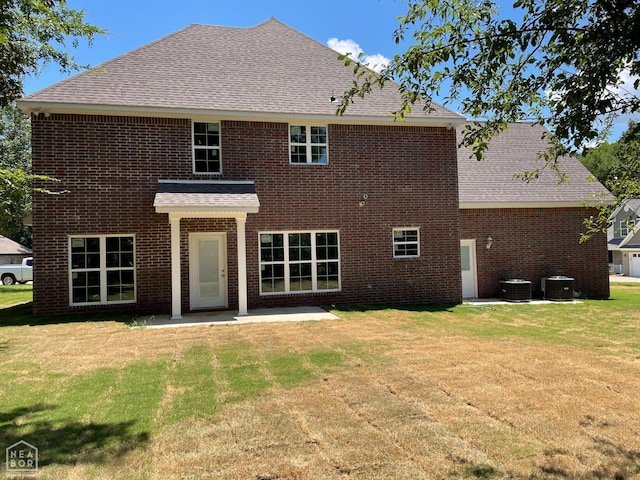 3502 Burdyshaw Dr Drive, Jonesboro, AR 72405 - back of property with brick siding, a patio area, central air condition unit, and a yard