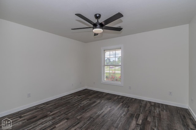 empty room with dark wood finished floors, baseboards, and a ceiling fan