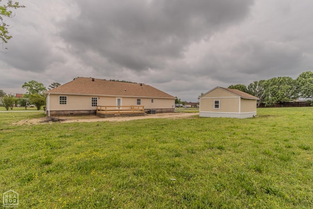 back of house with a wooden deck and a lawn