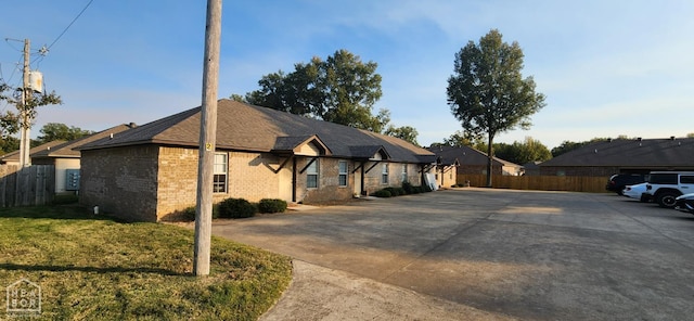 18 Brookland St, Brookland, AR 72417 - view of front facade with a front yard, fence, and brick siding