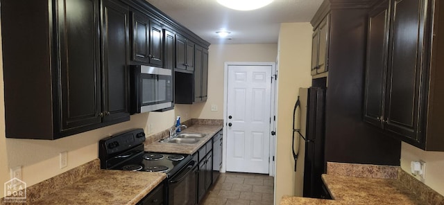 18 Brookland St, Brookland, AR 72417 - kitchen with a sink, light countertops, dark cabinetry, black appliances, and tile patterned floors