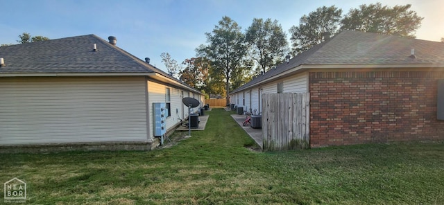 18 Brookland St, Brookland, AR 72417 - view of home's exterior with roof with shingles and a yard