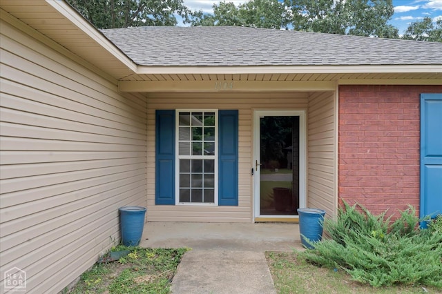 1104 Sandino Dr, Jonesboro, AR 72405 - view of exterior entry featuring roof with shingles and brick siding