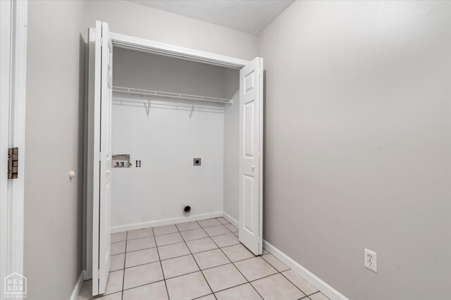 1104 Sandino Dr, Jonesboro, AR 72405 - laundry area with hookup for an electric dryer, light tile patterned floors, and washer hookup