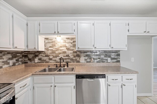 1104 Sandino Dr, Jonesboro, AR 72405 - kitchen featuring appliances with stainless steel finishes, white cabinets, light countertops, and decorative backsplash