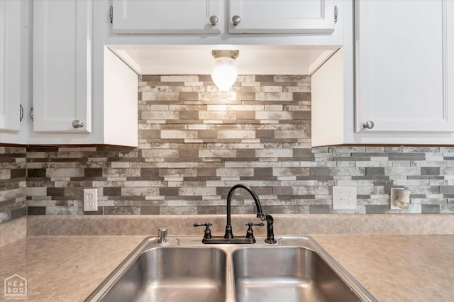 1104 Sandino Dr, Jonesboro, AR 72405 - kitchen view of light countertops, tasteful backsplash, and white cabinets