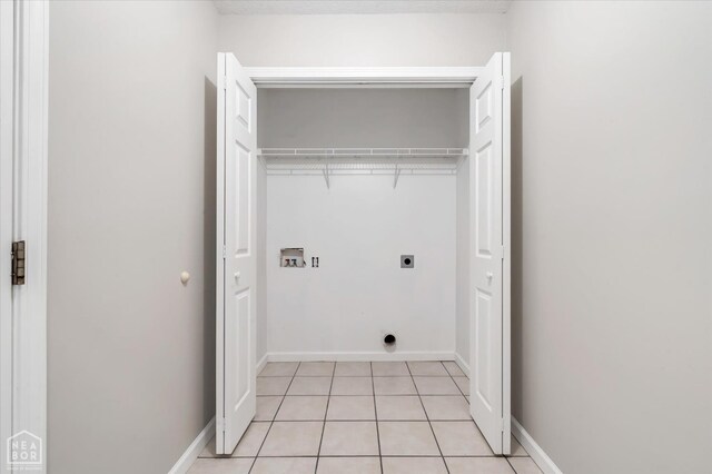 1104 Sandino Dr, Jonesboro, AR 72405 - washroom featuring hookup for an electric dryer, washer hookup, and light tile patterned floors