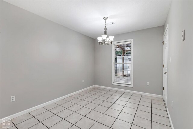 1104 Sandino Dr, Jonesboro, AR 72405 - spare room with a chandelier and light tile patterned flooring