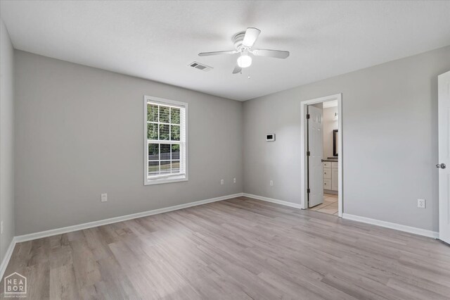 1104 Sandino Dr, Jonesboro, AR 72405 - unfurnished bedroom with light wood-style flooring, ensuite bathroom, and ceiling fan