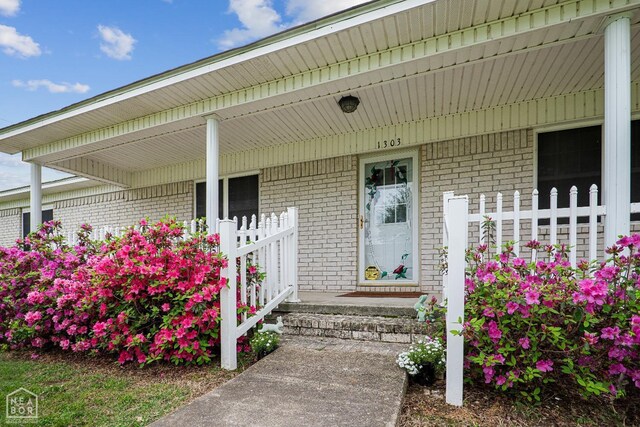 1303 Magnolia Ave, Walnut Ridge, AR 72476 - entrance to property with brick siding and covered porch