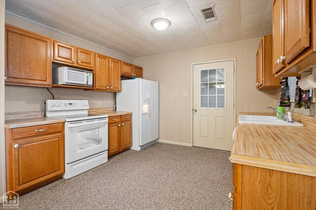 1303 Magnolia Ave, Walnut Ridge, AR 72476 - kitchen featuring a sink, white appliances, light countertops, ornamental molding, and visible vents