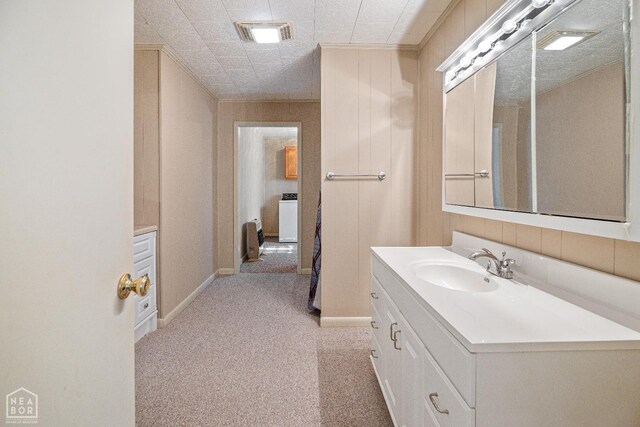 1303 Magnolia Ave, Walnut Ridge, AR 72476 - bathroom featuring baseboards, washer / dryer, vanity, and visible vents