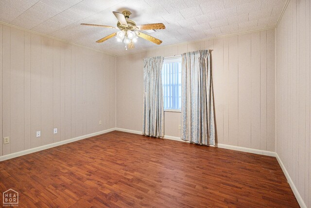 1303 Magnolia Ave, Walnut Ridge, AR 72476 - unfurnished room featuring ceiling fan, wood walls, crown molding, and wood finished floors
